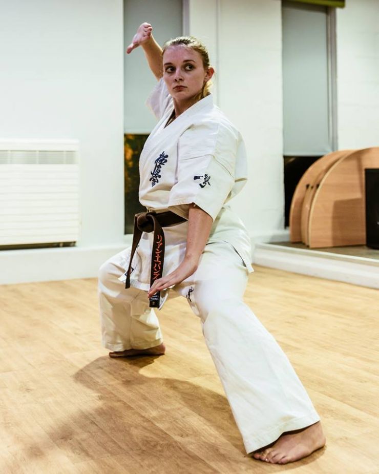 A woman learning karate.