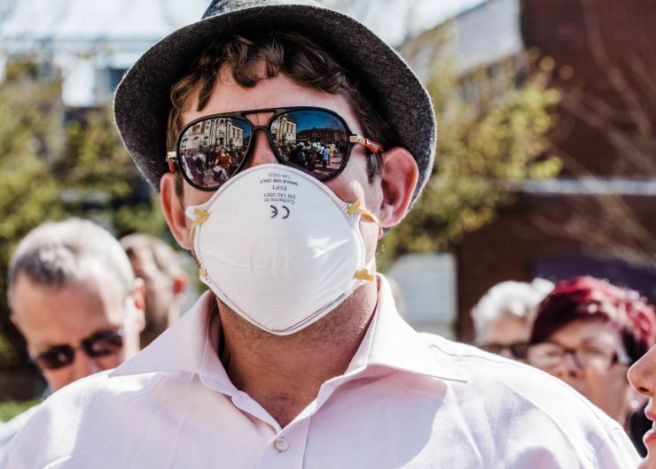 kevin moore captures the public protesting against the aviva incinerator, we see a man with mask